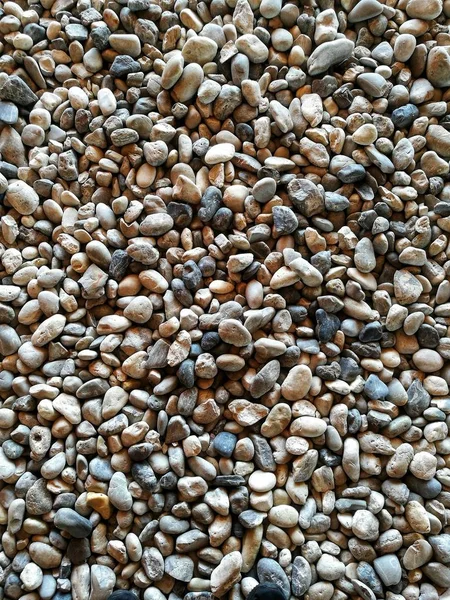 gravel on ground construction material for reference. ground and sub base layer of floor. river stone smooth curve edge stone.