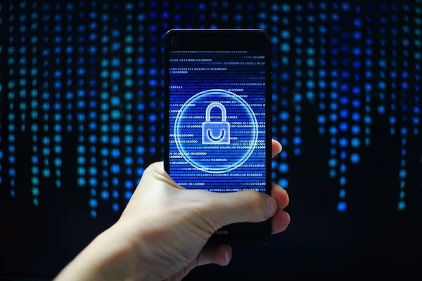 protected in stream of data flow. padlock icon symbolize security and motion movement of binary code computer data moving in the background. hand holding mobile phone.