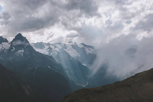 Panorama of mountains scene with dramatic cloudy sky in national