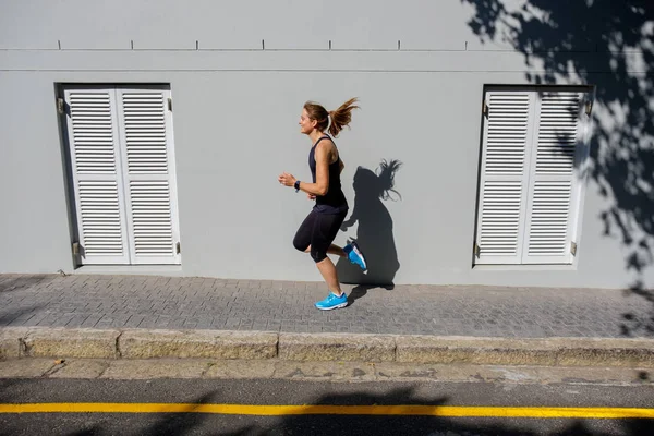 Bir yol boyunca çalışan kadın sprinter — Stok fotoğraf