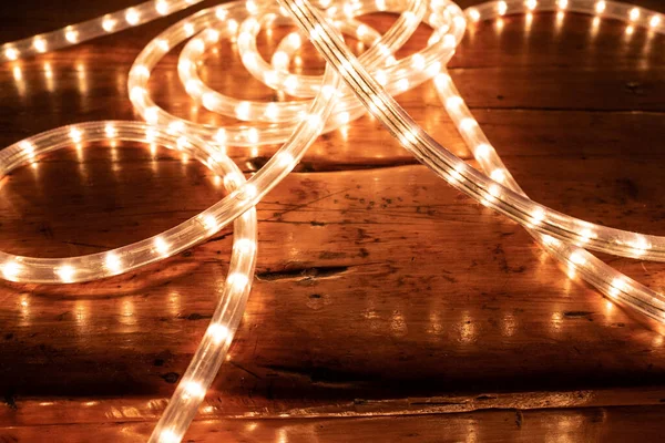 festive LED fairy lights on a vintage wooden table