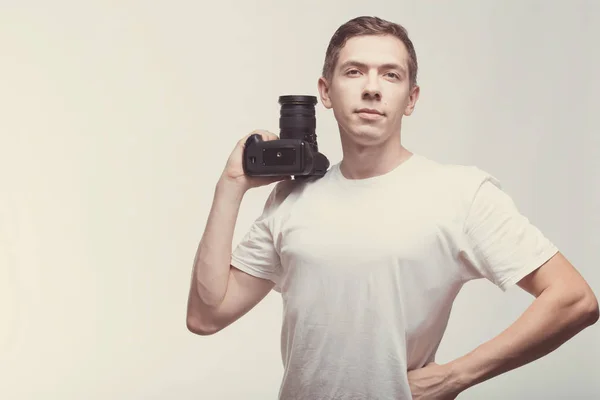 Serious Man with camera isolated on light background. Young man — Stock Photo, Image