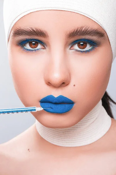 Beauty concept. Young model with blue lips and soft skin doing p — Stock Photo, Image