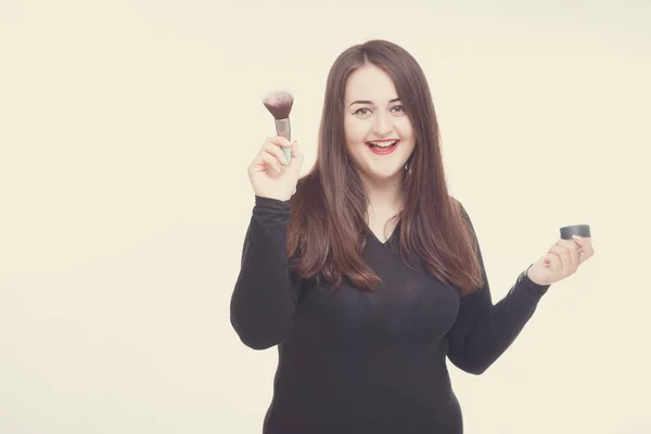 Model plus size with sweet donut, happy smiling girl posing with