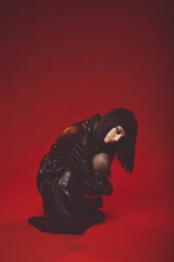 Siyah deri ceketli ve çoraplı çekici genç bir kadın.