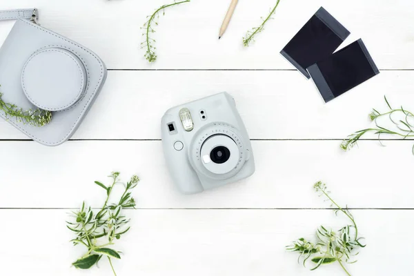 Vintage photo camera on white background with photo cards. Polaroid camera. Instax white camera. Flat lay. Eye bird view