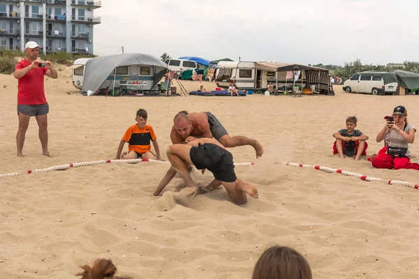 Zatoka, Odessa, Ukrayna - 16 Temmuz 2019: Gün batımında sahilde el ele mücadele