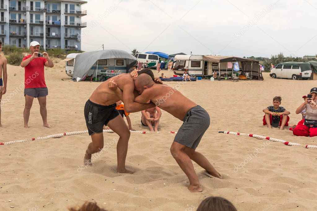 Zatoka, Odessa, Ukraine - July 16, 2019: Hand-to-hand combat on the beach at sunset