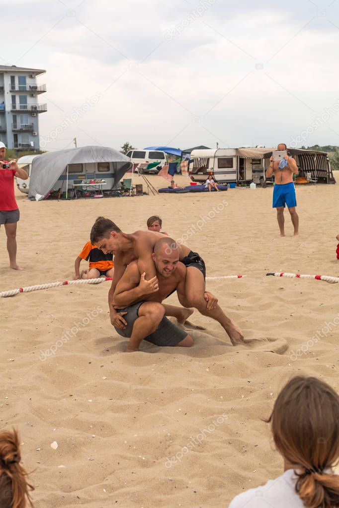 Zatoka, Odessa, Ukraine - July 16, 2019: Hand-to-hand combat on the beach at sunset