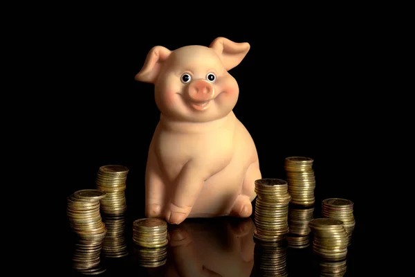 cute ceramic pig moneybox with lots of coins isolated on black background