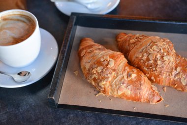 taze pişmiş kruvasanlar beyaz fincan aromalı kahve ile