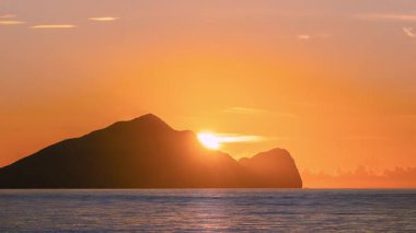 Morning scene in Zhuangwei Yilan Taiwan with a dreamy sunrise behind Guishan Island, casting a magical glow over the sea and sky.