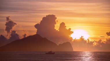 Time lapse of the sun slowly rising from behind Guishan Island in the Pacific Ocean near Zhuangwei Yilan Taiwan The golden light creates a dreamy and spectacular seascape at dawn