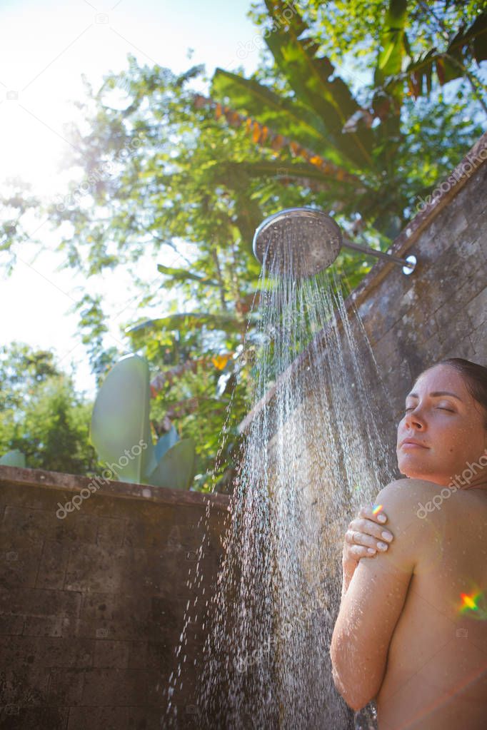 women in tropic shower