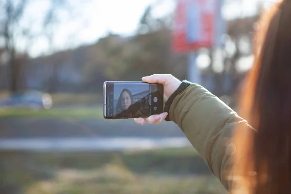 Girl taking photo on brand new Samsung Galaxy S10