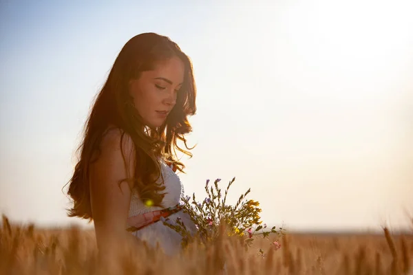 women portrait with flowers on sunset