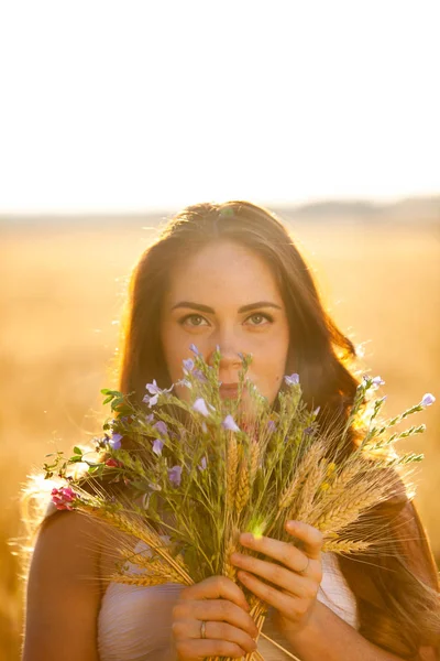 women portrait with flowers on sunset