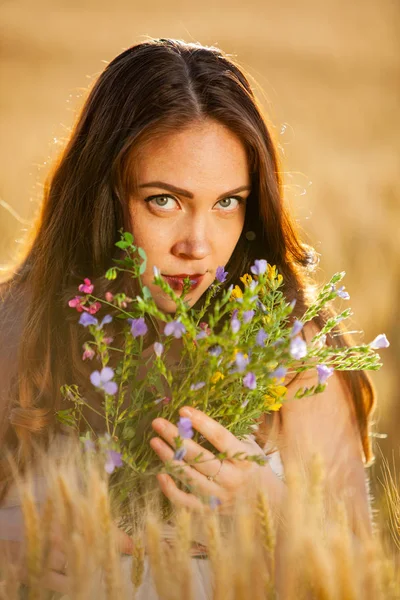 women portrait with flowers on sunset