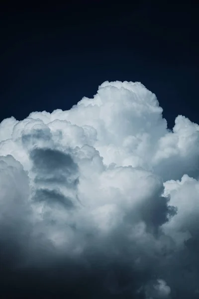 Thunder clouds in the dark blue sky