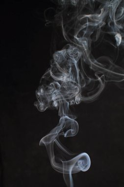Abstract white smoke texture on black background clipart
