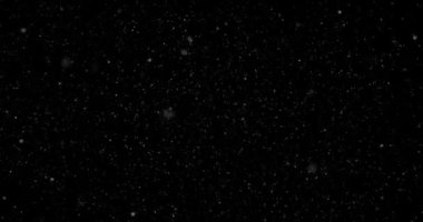 Siyah zemin üzerinde rastgele uçan küçük beyaz parçacıklara sahip video