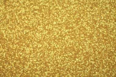 Parlak soyut parıltı dokusu dinamik tasarımı olan altın arkaplan