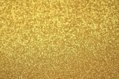 Parlak soyut parıltı dokusu dinamik tasarımı olan altın arkaplan