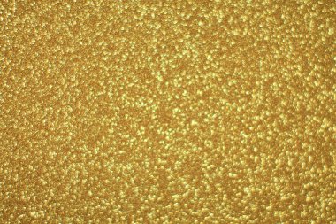 Parlak soyut parıltı dokusu dinamik tasarımı olan altın arkaplan