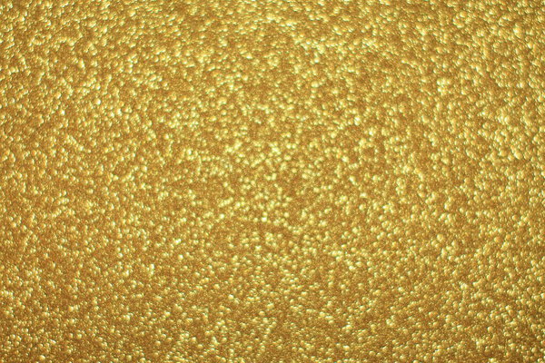 Bright abstract glitter texture gold background with dynamic design