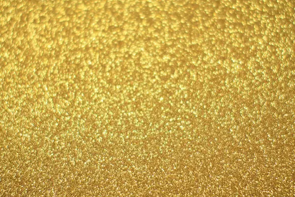 Parlak soyut parıltı dokusu dinamik tasarımı olan altın arkaplan