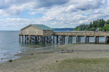 A veiw of the pier at Rodondo Beach, Washington. The tide is low. clipart