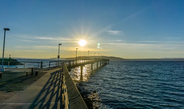 Des Moines, Washington'da iskelede aşağı güneş parlıyor.