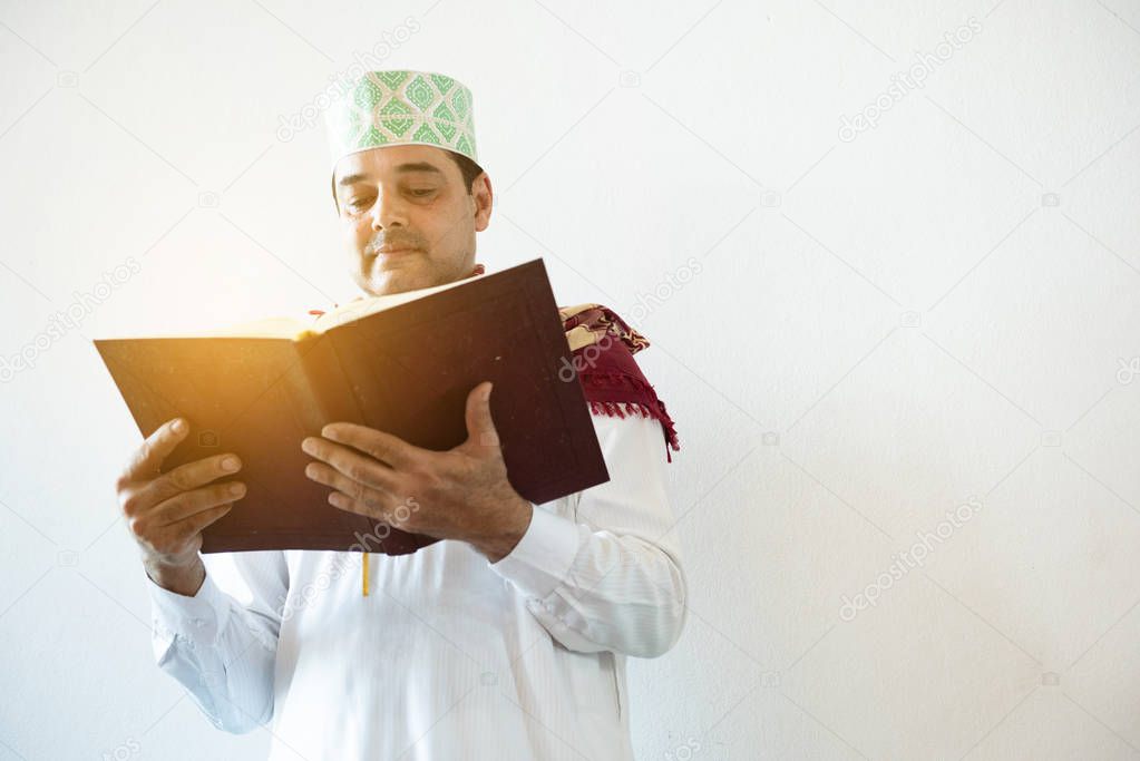Muslim business or college student man reading holy prayer book,