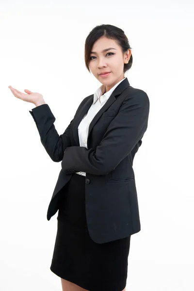 黒いスーツを着た若いアジア人女性が笑顔で手のひらを開き、クリッピングパスで白い背景に隔離された — ストック写真