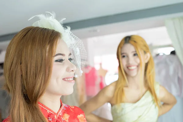 Happy two asia women dress up in fitting room with happy and funny face