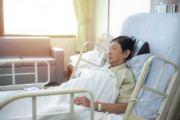 Asian senior or elderly old lady woman patient lying on bed in nursing ward hospital.