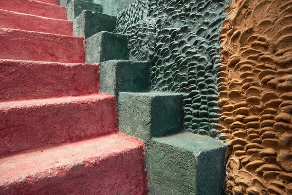 Outdoor stairs of green and red color.