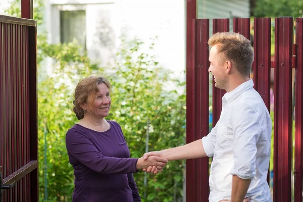 Neighbors Discuss News Standing Fence Elderly Woman Talking Young Man — Stock Photo, Image