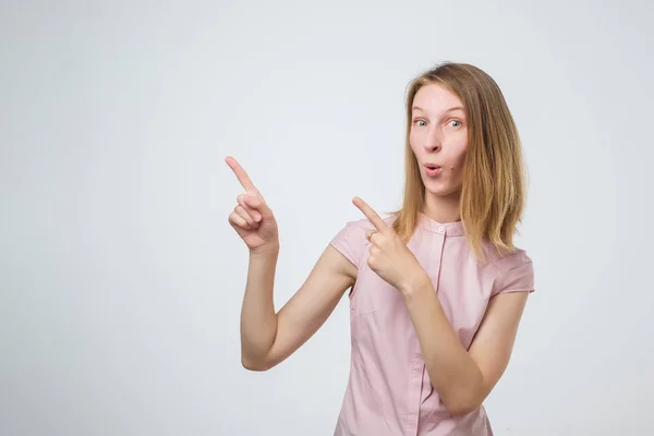 Pretty cheerful european woman gesturing with fingers and showing away — Stock Photo, Image