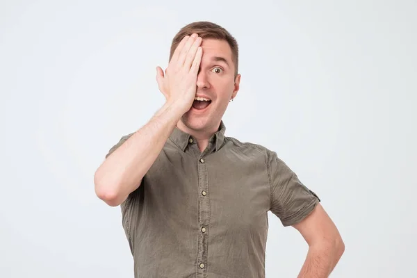 Young man covers eyes with hands, does not see clearly — Stock Photo, Image