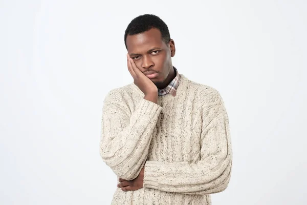 Boring, dull, tedious concept. Young african man looking at camera sadly — Stock Photo, Image