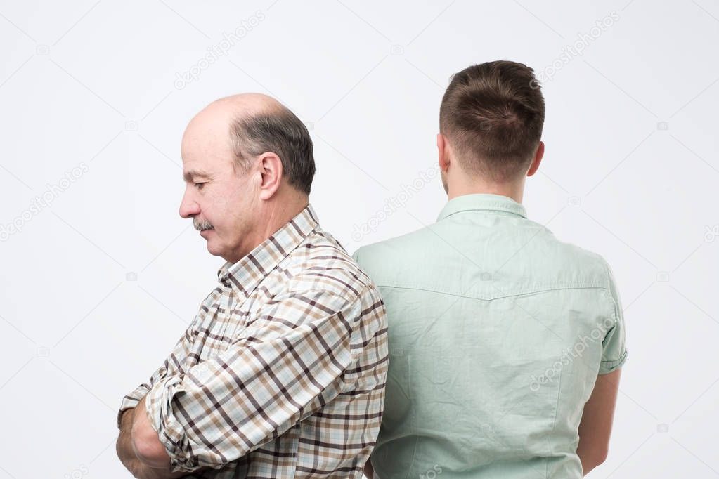 Mature son is crying on his father shoulder and feeling upset cause from his mistake.