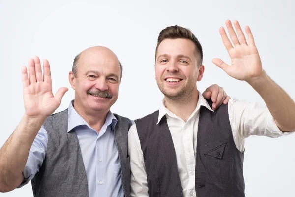 Two men saying hello, waving a hand — Stock Photo, Image