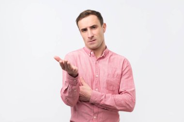 Pembe gömlekli üzgün mutsuz genç adam karısıyla kavga sonra huysuz ifadesi olan.