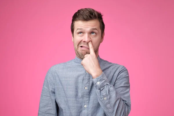 Young european man is picking his nose — Stock Photo, Image