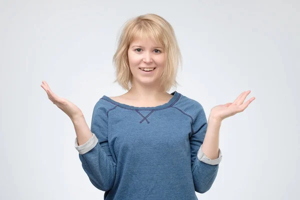 Радостная блондинка, одетая в голубого пуловера, шокирована — стоковое фото