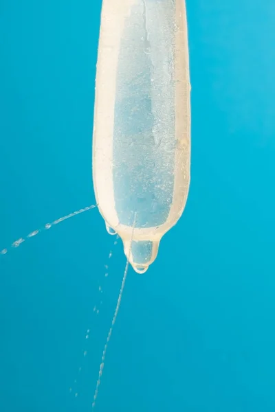 Water is leaked from a condom full of holes. Control test for the quality.