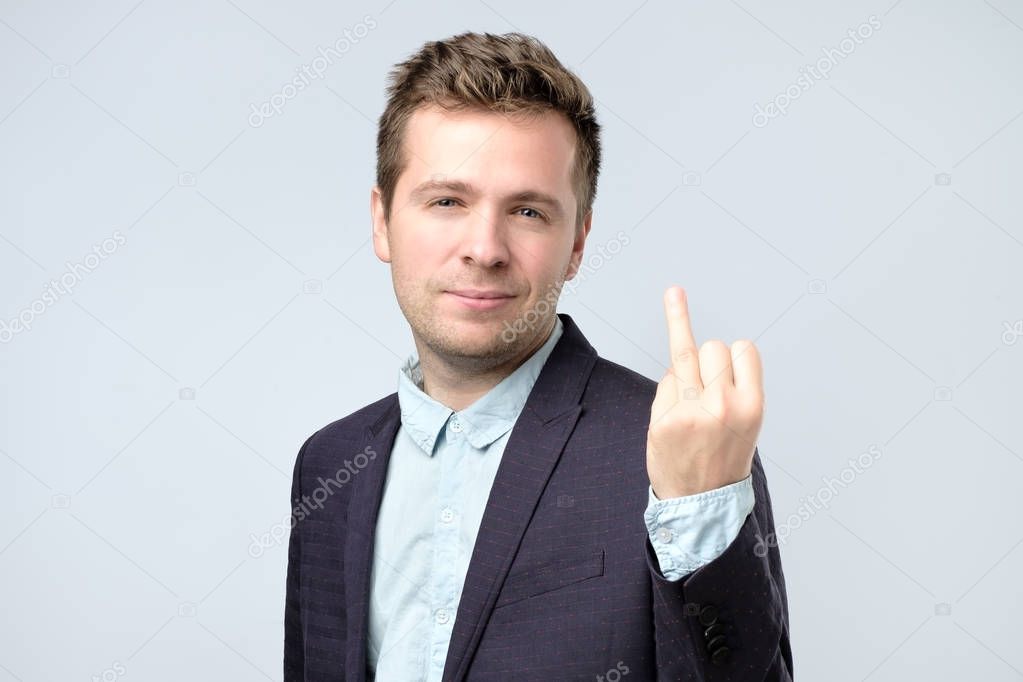 Caucasian man in suit showing his finger without marriage ring.