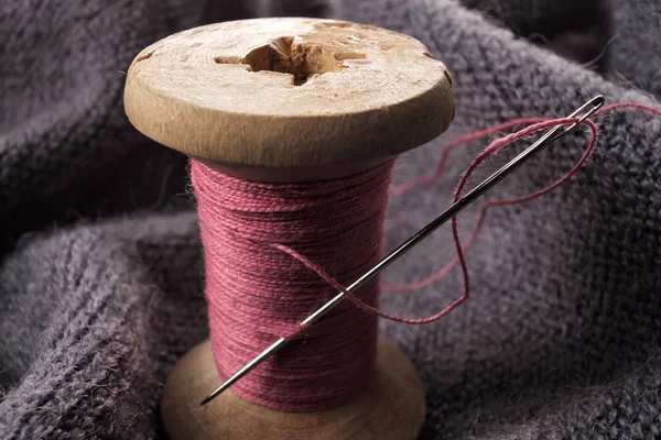 Швейная иголка и хлопковая нить на деревянной катушке . — стоковое фото