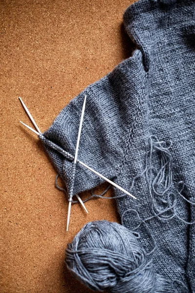 Incomplete knitting gray sweater for child with needles — Stock Photo, Image